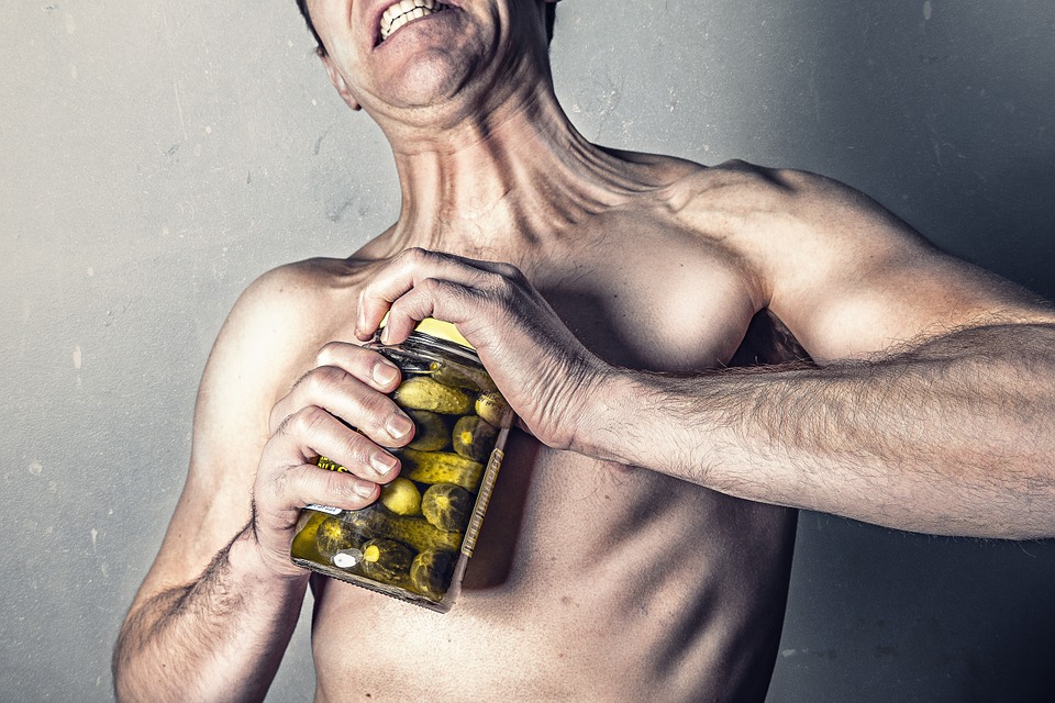 man holding a bottle of supplements