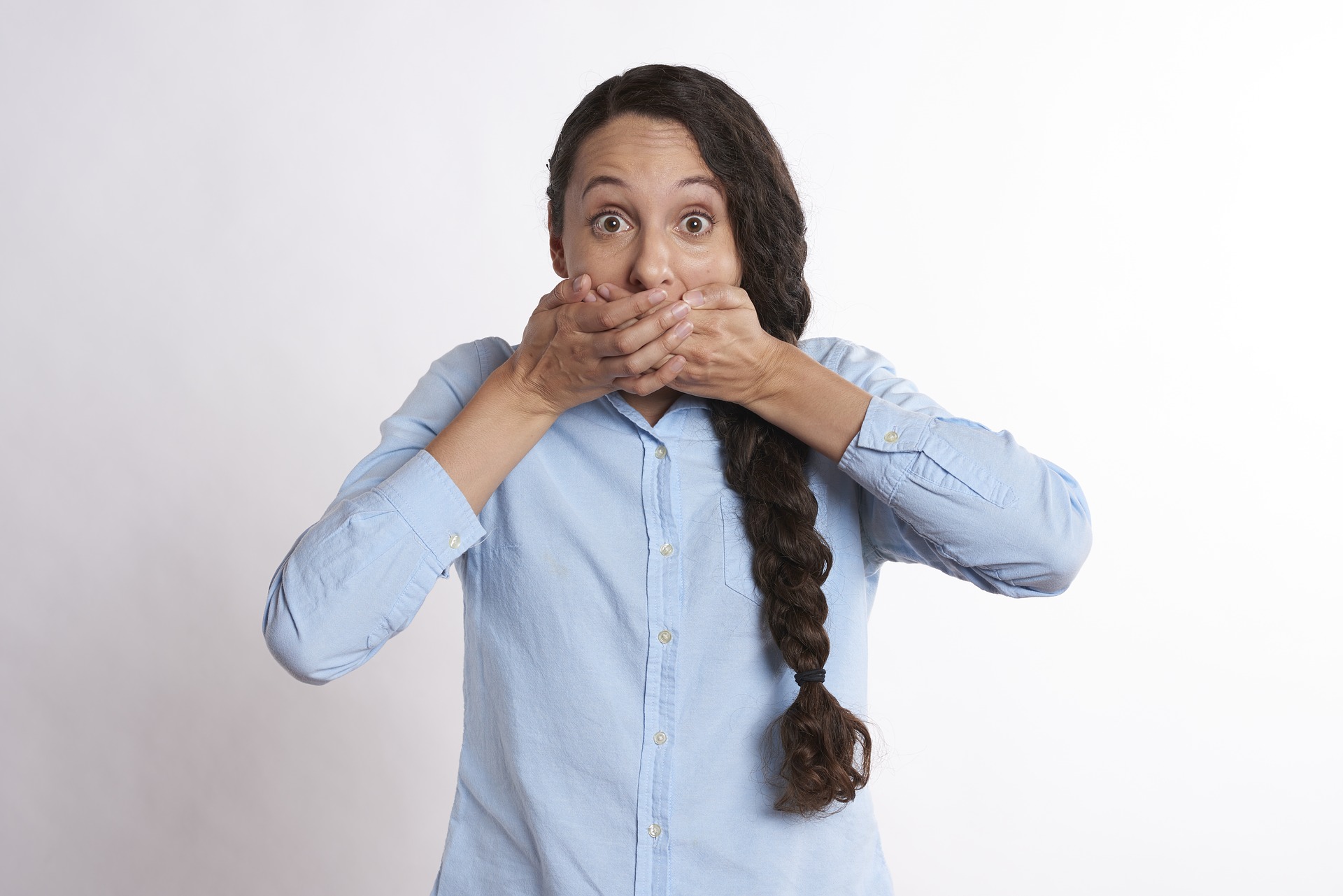 a woman covering her mouth