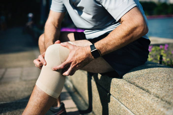 a man holding his knee